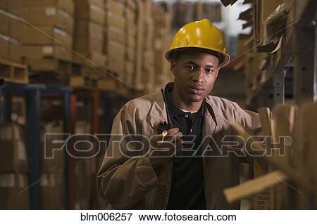 Black man with walkie-talkie working in warehouse View Large Photo Image Stock Photo - Black man with walkie-talkie working in warehouse. Fotosearch