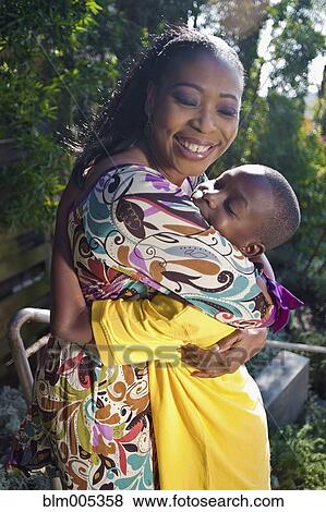Black mother hugging son outdoors View Large Photo Image Stock Photo - Black mother hugging son outdoors. Fotosearch