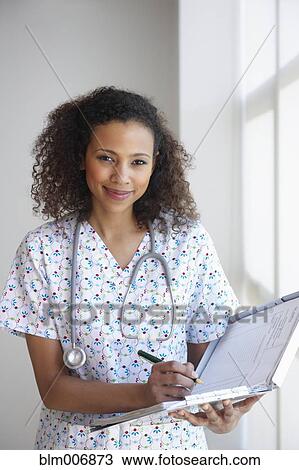 Black nurse writing on medical chart View Large Photo Image Stock Image - Black nurse writing on medical chart. Fotosearch