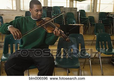 Stock Photograph - Black student practicing on violin. Fotosearch