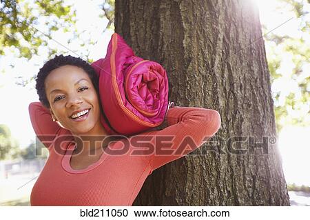Black woman carrying yoga mat outdoors View Large Photo Image Stock Image - Black woman carrying yoga mat outdoors. Fotosearch