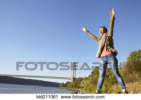 Black woman cheering by river View Large Photo Image Stock Image - Black woman cheering by river. Fotosearch