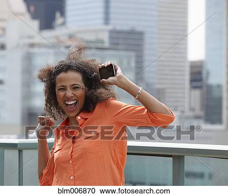 Black woman dancing with cell phone View Large Photo Image Stock Image - Black woman dancing with cell phone. Fotosearch