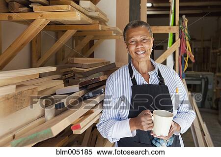 Black woman drinking coffee in carpentry shop View Large Photo Image Stock Photography - Black woman drinking coffee in carpentry shop. Fotosearch