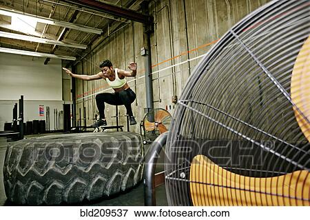 Stock Photo - Black woman exercising in gym. Fotosearch