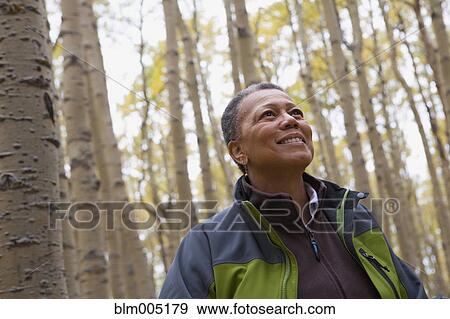 Stock Photo - Black woman in forest. Fotosearch