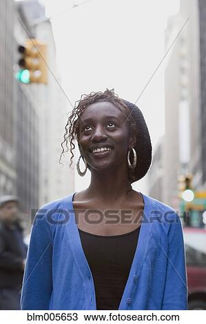 Stock Image - Black woman on urban street. Fotosearch