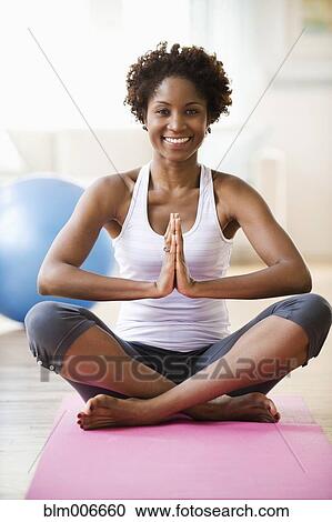 Stock Image - Black woman practicing yoga. Fotosearch