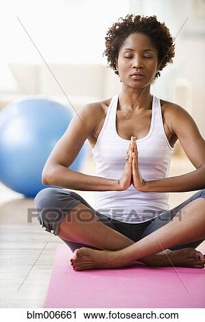 Stock Image - Black woman practicing yoga. Fotosearch