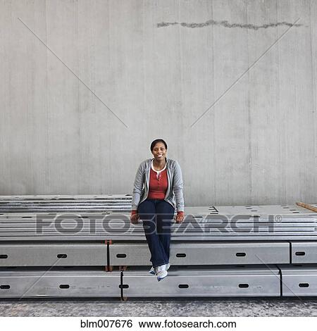 Black woman sitting in metal rails View Large Photo Image Stock Photograph - Black woman sitting in metal rails. Fotosearch