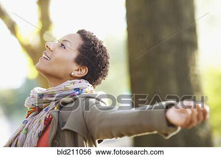 Stock Photograph - Black woman standing outdoors. Fotosearch
