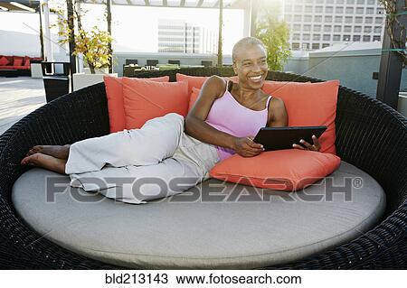 Black woman using digital tablet on urban rooftop View Large Photo Image Stock Image - Black woman using digital tablet on urban rooftop. Fotosearch