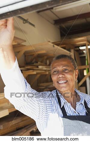 Black woman working in carpentry shop View Large Photo Image Stock Photograph - Black woman working in carpentry shop. Fotosearch