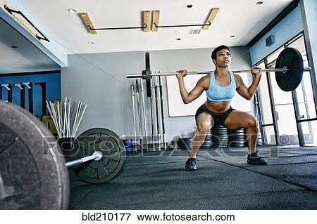 Black woman working out in gym View Large Photo Image Stock Photo - Black woman working out in gym. Fotosearch