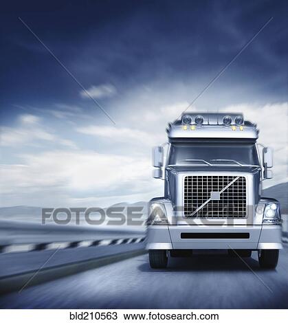Stock Image - Blurred view of semi-truck driving on freeway. Fotosearch