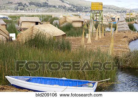 Stock Photograph - Boat mooring in lake by rural village, Lake Titicaca, Peru. Fotosearch
