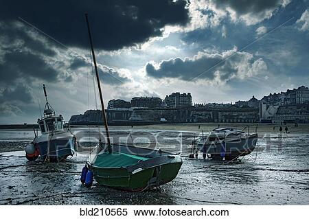 Stock Photography - Boats stranded on urban beach, Broad Stairs, Isle of Thanet, United Kingdom. Fotosearch