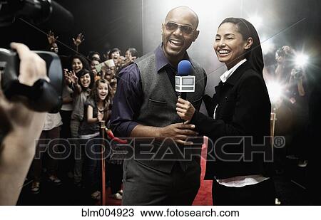 Stock Image - Broadcaster interviewing celebrity. Fotosearch