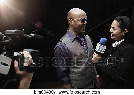 Broadcaster interviewing celebrity View Large Photo Image Stock Photo - Broadcaster interviewing celebrity. Fotosearch