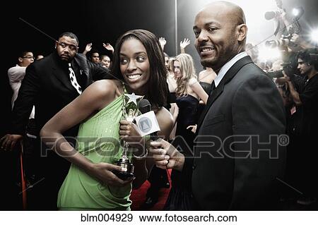 Broadcaster interviewing celebrity with award View Large Photo Image Stock Photo - Broadcaster interviewing celebrity with award. Fotosearch