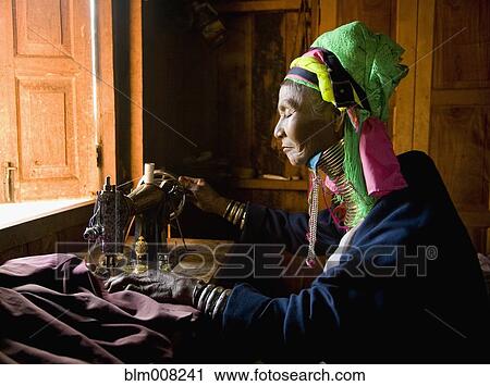 Burmese woman wearing neck rings at sewing machine View Large Photo Image Stock Image - Burmese woman wearing neck rings at sewing machine. Fotosearch