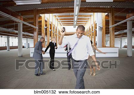 Stock Image - Business people dancing in empty office space. Fotosearch