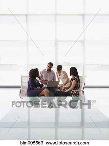 Stock Photo - Business people having meeting in office. Fotosearch