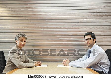 Stock Image - Business people having meeting in conference room. Fotosearch