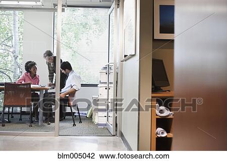 Stock Image - Business people in meeting in conference room. Fotosearch