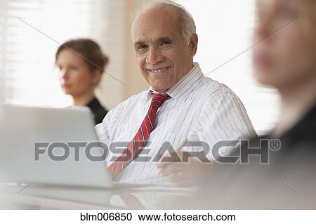 Business people listening in meeting View Large Photo Image Stock Image - Business people listening in meeting. Fotosearch