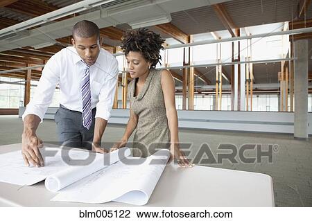Business people looking at blueprints View Large Photo Image Stock Image - Business people looking at blueprints. Fotosearch