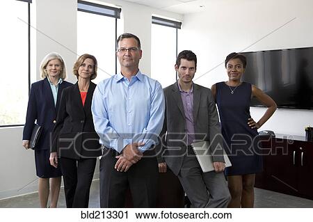 Business people smiling together in office View Large Photo Image Stock Image - Business people smiling together in office. Fotosearch