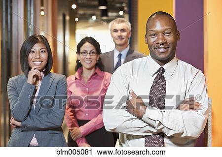 Business people standing in office hallway View Large Photo Image Stock Image - Business people standing in office hallway. Fotosearch