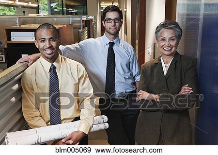 Stock Photo - Business people standing in office hallway. Fotosearch