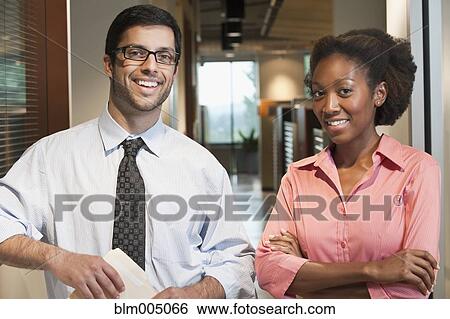 Stock Photograph - Business people standing in office. Fotosearch