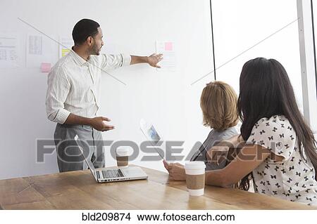 Picture - Business people talking in meeting. Fotosearch