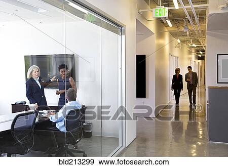 Business people talking in office View Large Photo Image Stock Photo - Business people talking in office. Fotosearch