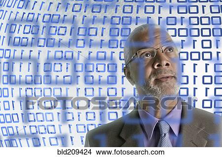 Picture - Businessman reading binary code. Fotosearch