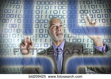 Stock Photography - Businessman reading binary code. Fotosearch