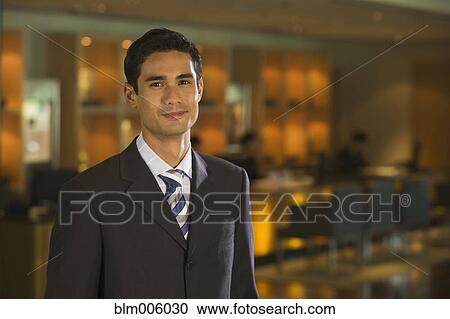 Stock Image - Businessman smiling in bar. Fotosearch