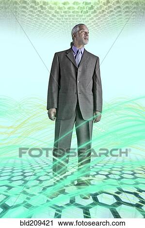 Stock Image - Businessman surrounded by glowing lines. Fotosearch