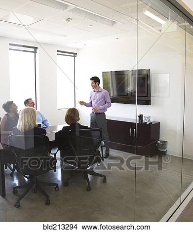 Businessman talking in meeting View Large Photo Image Picture - Businessman talking in meeting. Fotosearch