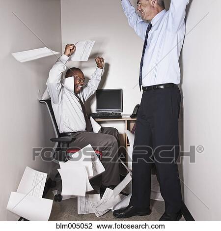 Businessmen cheering in small office View Large Photo Image Stock Image - Businessmen cheering in small office. Fotosearch