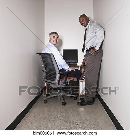 Businessmen having meeting in small office View Large Photo Image Stock Image - Businessmen having meeting in small office. Fotosearch