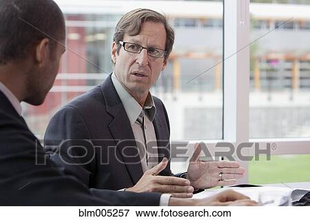 Stock Photo - Businessmen talking. Fotosearch
