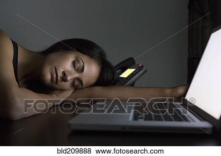 Businesswoman sleeping at desk at night View Large Photo Image Stock Photo - Businesswoman sleeping at desk at night. Fotosearch