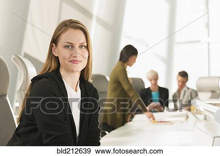 Stock Photo - Businesswoman smiling in meeting. Fotosearch