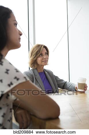 Businesswomen listening in meeting View Large Photo Image Picture - Businesswomen listening in meeting. Fotosearch