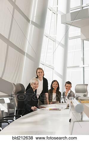 Stock Photo - Businesswomen smiling in meeting. Fotosearch