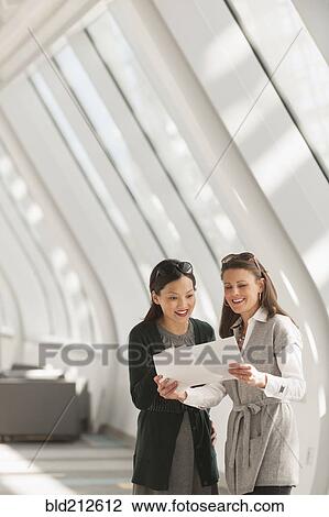 Businesswomen talking in lobby View Large Photo Image Stock Image - Businesswomen talking in lobby. Fotosearch